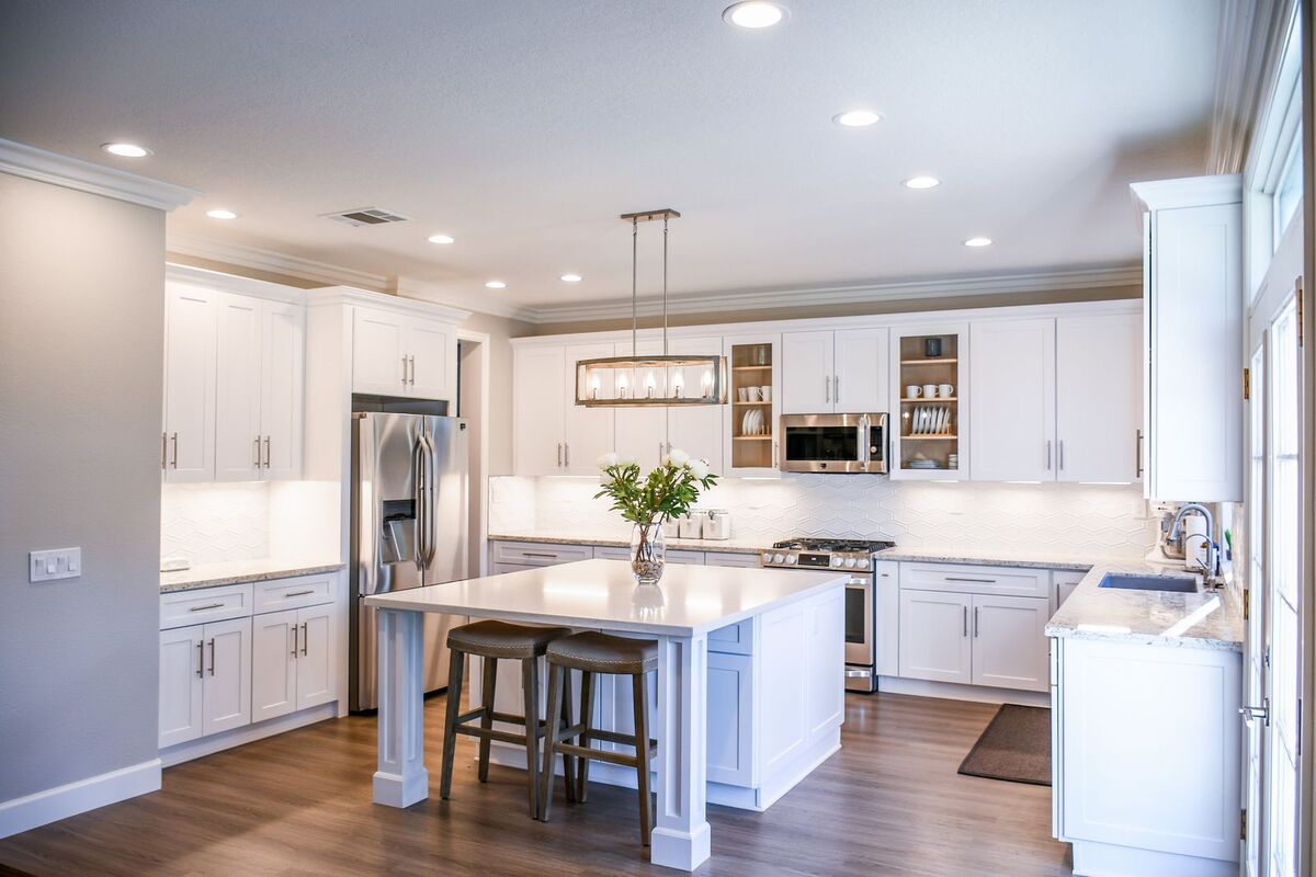 White kitchen with LED pot lights over the counters and island
